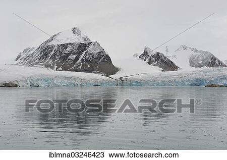 Stock Image - "Ice edge and peaks, Smeerenburg Glacier, Smeerenburgfjorden, Spitsbergen Island, Svalbard Archipelago, Svalbard and Jan Mayen, Norway, Europe". Fotosearch
