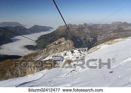 Ice Flyer chairlift, Titlis Mountain, Obwalden, Switzerland, Europe View Large Photo Image Stock Photo - Ice Flyer chairlift, Titlis Mountain, Obwalden, Switzerland, Europe. Fotosearch