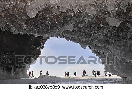 "Ice formations and icicles hanging from ceiling in a cave and people walking on frozen Lake Superior, Apostle Islands National Lakeshore, Bayfield, Wisconsin, USA" View Large Photo Image Stock Photo - "Ice formations and icicles hanging from ceiling in a cave and people walking on frozen Lake Superior, Apostle Islands National Lakeshore, Bayfield, Wisconsin, USA". Fotosearch