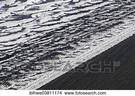 Picture - "Ice on the Elbe River, ice floes are deposited on the beach by the tides, bizarre ice floes on the Elbe River, Hamburg, Germany, Europe". Fotosearch