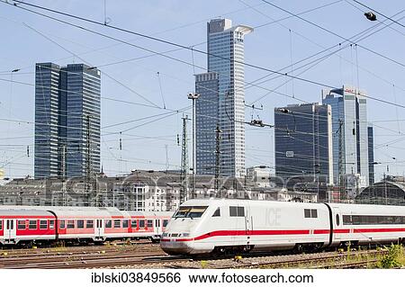 Stock Photograph - "ICE train on the tracks of Deutsche Bahn AG at Frankfurt main station, at the back the skyline of Frankfurt with the towers of Volksbank and Deka Bank, Frankfurt am Main, Hesse, Germany, Europe". Fotosearch