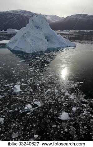 Stock Photo - "Iceberg surrounded by smaller pieces of ice, Scoresbysund, Sermersooq, Greenland, North America". Fotosearch