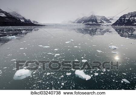 "Icebergs in front of cloud veiled mountain and glacier scenery, Vikingebugt, Scoresbysund, Sermersooq, Greenland, North America" View Large Photo Image Stock Photo - "Icebergs in front of cloud veiled mountain and glacier scenery, Vikingebugt, Scoresbysund, Sermersooq, Greenland, North America". Fotosearch