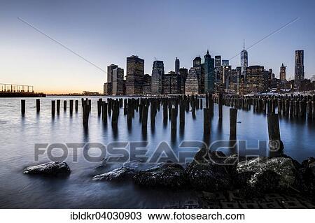 Stock Image - "ier at Brooklyn Bridge Park with view of the East River and the skyline of Manhattan, Brooklyn Heights, Brooklyn, New York, United States, North America". Fotosearch
