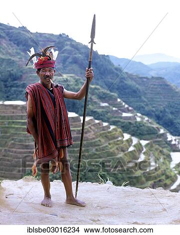 "Ifugao man, a member of an ethnic group wearing a traditional costume, Banaue Rice Terraces, also known as musuan peak, at the back, Banaue, Ifugao, Luzon, Philippines, Asia" View Large Photo Image Picture - "Ifugao man, a member of an ethnic group wearing a traditional costume, Banaue Rice Terraces, also known as musuan peak, at the back, Banaue, Ifugao, Luzon, Philippines, Asia". Fotosearch
