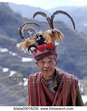 "Ifugao man, a member of an ethnic group wearing a traditional costume, Banaue Rice Terraces, also known as musuan peak, at the back, Banaue, Ifugao, Luzon, Philippines, Asia" View Large Photo Image Stock Photography - "Ifugao man, a member of an ethnic group wearing a traditional costume, Banaue Rice Terraces, also known as musuan peak, at the back, Banaue, Ifugao, Luzon, Philippines, Asia". Fotosearch