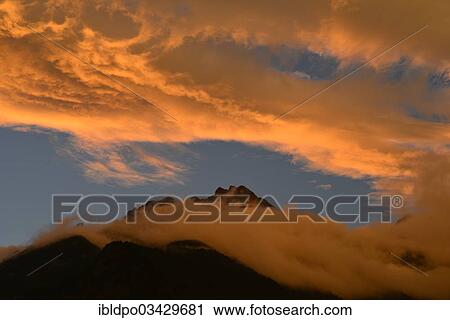 Stock Image - "Illuminated clouds above Brandjochspitze mountain, Inntalkette range, near Innsbruck, Tyrol, Austria, Europe". Fotosearch