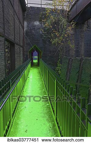 Stock Image - "Illuminated former coal bunkers, disused steelworks, Landscape Park Duisburg-Nord, Ruhr area, North Rhine-Westphalia, Germany, Europe". Fotosearch