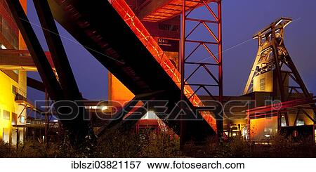 "Illuminated gangway to the Ruhr Museum at the Zeche Zollverein Coal Mine Shaft XII with the headframe, Essen, Ruhr area, North Rhine-Westphalia, Germany, Europe" View Large Photo Image Stock Photo - "Illuminated gangway to the Ruhr Museum at the Zeche Zollverein Coal Mine Shaft XII with the headframe, Essen, Ruhr area, North Rhine-Westphalia, Germany, Europe". Fotosearch