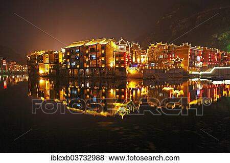 Stock Photo - "Illuminated houses on the Wuyang River at night, historic center, Zhenyuan, Guizhou, China, People's Republic of China, Asia". Fotosearch