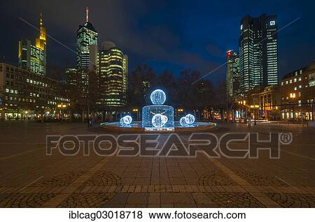 "Illuminated Lucae Fountain on Opernplatz square in front of illuminated high-rise skyline, Westend, Frankfurt am Main, Hesse, Germany, Europe" View Large Photo Image Stock Photo - "Illuminated Lucae Fountain on Opernplatz square in front of illuminated high-rise skyline, Westend, Frankfurt am Main, Hesse, Germany, Europe". Fotosearch