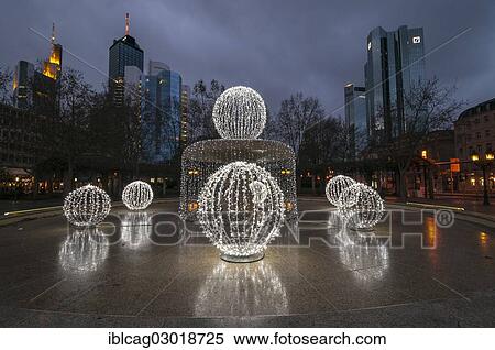 Stock Photography - "Illuminated Lucae Fountain on Opernplatz square in front of high-rise skyline, Westend, Frankfurt am Main, Hesse, Germany, Europe". Fotosearch