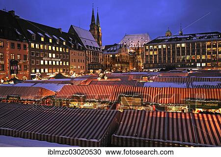 Stock Image - "Illuminated Nuremberg Christmas market, Town Hall, Schoene Brunnen or Beautiful Fountain and St. Sebald Church at the rear, Hauptmarkt, Altstadt, Nuremberg, Middle Franconia, Bavaria, Germany, Europe". Fotosearch