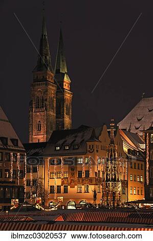 Stock Photo - "Illuminated Nuremberg Christmas market, Schoene Brunnen or Beautiful Fountain and St. Sebald Church at the rear, Hauptmarkt, Innenstadt, Nuremberg, Middle Franconia, Bavaria, Germany, Europe". Fotosearch