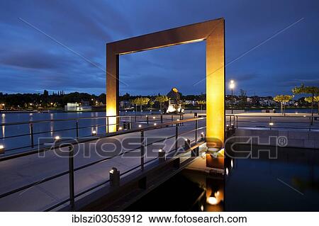 "Illuminated promenade with the Thomas Smelting Furnace on Kulturinsel, the cultural island in Phoenix-See lake at dusk, Dortmund, Ruhr district, North Rhine-Westphalia, Germany, Europe" View Large Photo Image Stock Image - "Illuminated promenade with the Thomas Smelting Furnace on Kulturinsel, the cultural island in Phoenix-See lake at dusk, Dortmund, Ruhr district, North Rhine-Westphalia, Germany, Europe". Fotosearch