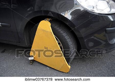 "Immobilizer, wheel clamp on the wheel of a car parked in a prohibited parking area, England, United Kingdom, Europe" View Large Photo Image Stock Photo - "Immobilizer, wheel clamp on the wheel of a car parked in a prohibited parking area, England, United Kingdom, Europe". Fotosearch