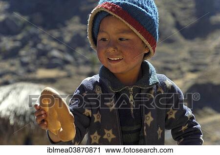 "Indian boy holding bread in his hand, near Cusco, Andes, Peru, South America" View Large Photo Image Stock Image - "Indian boy holding bread in his hand, near Cusco, Andes, Peru, South America". Fotosearch