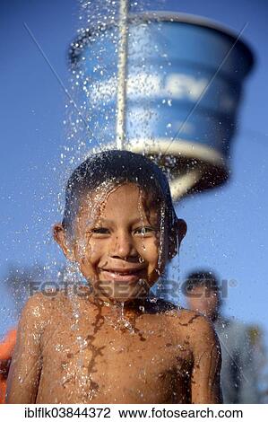 "Indian boy of the Xavantes people taking a shower at the water point of a well, installed by missionaries, in the village of Tres Rios near Sangradouro, Primavera do Leste, Mato Grosso, Brazil, South America" View Large Photo Image Stock Image - "Indian boy of the Xavantes people taking a shower at the water point of a well, installed by missionaries, in the village of Tres Rios near Sangradouro, Primavera do Leste, Mato Grosso, Brazil, South America". Fotosearch