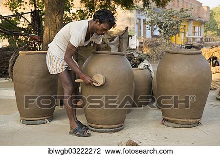 "Indian man forming huge clay pots with a wooden tool, Khajuraho, Madhya Pradesh, India, Asia" View Large Photo Image Stock Image - "Indian man forming huge clay pots with a wooden tool, Khajuraho, Madhya Pradesh, India, Asia". Fotosearch