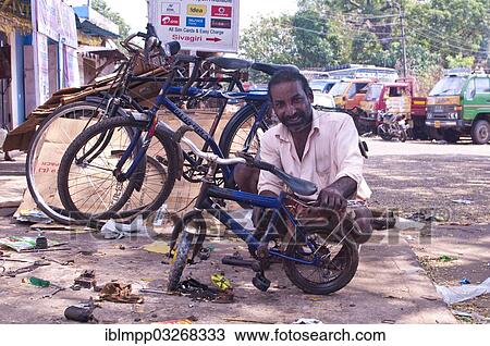 "Indian man repairing a children's bicycle, Varkala, Kerala, India, Asia" View Large Photo Image Stock Image - "Indian man repairing a children's bicycle, Varkala, Kerala, India, Asia". Fotosearch