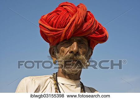 Stock Photo - "Indian man with a red turban and earrings, portrait, Pushkar, Rajasthan, India, Asia". Fotosearch