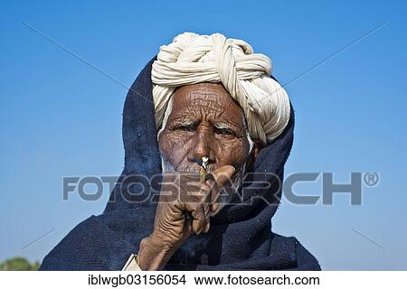 "Indian man with a white turban smoking a bidi cigarette, Pushkar, Rajasthan, India, Asia" View Large Photo Image Picture - "Indian man with a white turban smoking a bidi cigarette, Pushkar, Rajasthan, India, Asia". Fotosearch