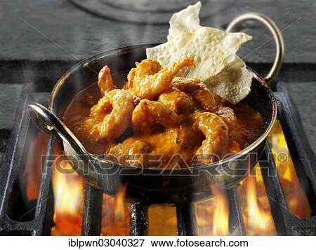 Indian prawn Makhani curry being cooked over hot charcoals View Large Photo Image Stock Photo - Indian prawn Makhani curry being cooked over hot charcoals. Fotosearch