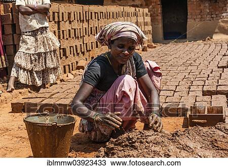 Stock Image - "Indian woman producing adobe bricks, Usilampatti, Tamil Nadu, India, Asia". Fotosearch