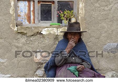 "Indigenous woman chewing coca in front of her hut, La Paz, Altiplano, Bolivia, Andes, South America" View Large Photo Image Stock Photo - "Indigenous woman chewing coca in front of her hut, La Paz, Altiplano, Bolivia, Andes, South America". Fotosearch