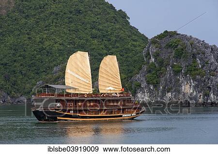 "Indochina Sails"""", a junk in front of limestone cliffs in Halong Bay, Gulf of Tonkin, North Vietnam, Vietnam, Asia" View Large Photo Image Stock Photo - "Indochina Sails"""", a junk in front of limestone cliffs in Halong Bay, Gulf of Tonkin, North Vietnam, Vietnam, Asia". Fotosearch