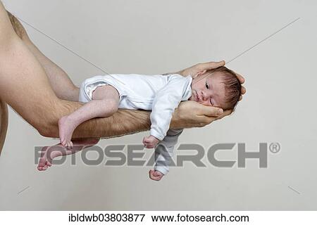 "Infant, 3 weeks, boy on the arms of his father" View Large Photo Image Stock Photo - "Infant, 3 weeks, boy on the arms of his father". Fotosearch