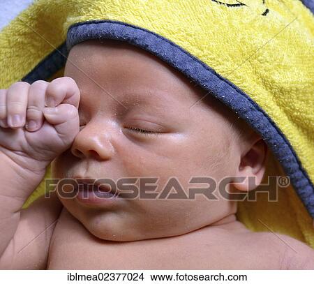 Picture - "Infant, 3 weeks old, wrapped in a towel after a bath". Fotosearch
