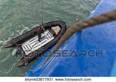 "Inflatable boat being hoisted aboard an expedition ship following an excursion, Spitsbergen Island, Svalbard Archipelago, Svalbard and Jan Mayen, Norway, Europe" View Large Photo Image Stock Image - "Inflatable boat being hoisted aboard an expedition ship following an excursion, Spitsbergen Island, Svalbard Archipelago, Svalbard and Jan Mayen, Norway, Europe". Fotosearch