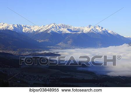 Stock Photography - "Inn Valley covered by a blanket of fog, Innsbruck, Tyrol, Austria, Europe". Fotosearch