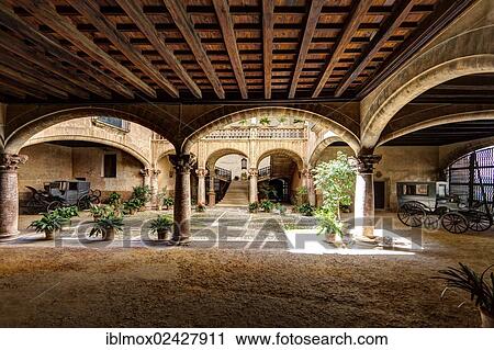 Stock Image - "Inner courtyard with old carriages, historic town centre, Palma de Majorca, Majorca, Balearic Islands, Spain, Europe". Fotosearch