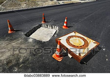 Stock Photo - "Installation of a manhole cover, Obersendling, Munich, Upper Bavaria, Bavaria, Germany, Europe". Fotosearch