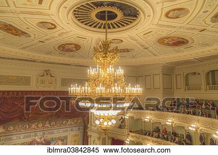 Stock Photography - "Interior view of the Semperoper opera house, chandelier on the stuccoed ceiling and the """"five-minute clock"""", Dresden, Saxony, Germany, Europe". Fotosearch