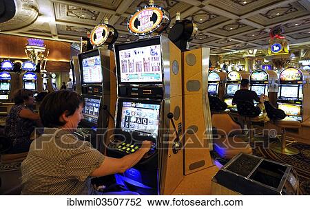 "Interior, woman playing a slot machine, one-armed bandits, luxury hotel, casino, Caesars Palace, Las Vegas, Nevada, United States, North America" View Large Photo Image Stock Image - "Interior, woman playing a slot machine, one-armed bandits, luxury hotel, casino, Caesars Palace, Las Vegas, Nevada, United States, North America". Fotosearch
