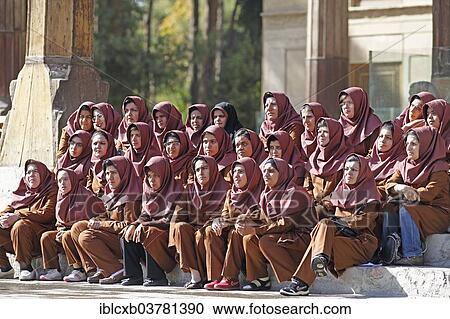 Stock Image - "Iranian girls posing for a class photo wearing uniforms, disabled girls and women, Chehel Sotun Palace Garden, Isfahan, Isfahan Province, Persia, Iran, Asia". Fotosearch