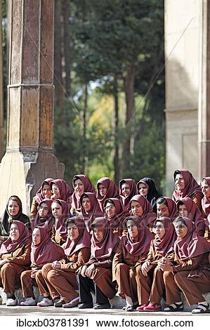 Stock Image - "Iranian girls posing for a class photo wearing uniforms, disabled girls and women, Chehel Sotun Palace Garden, Isfahan, Isfahan Province, Persia, Iran, Asia". Fotosearch