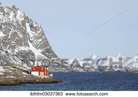 Stock Image - "Isolated red house beside the fjord in winter, Vestvagoy, Lofoten, Nordland, Northern Norway, Norway, Europe". Fotosearch