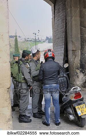 "Israeli soldiers checking a Palestinian motorcyclist in the Arab district, at the Lions' Gate, Jerusalem, Israel, Asia, Middle East, Asia" View Large Photo Image Stock Photography - "Israeli soldiers checking a Palestinian motorcyclist in the Arab district, at the Lions' Gate, Jerusalem, Israel, Asia, Middle East, Asia". Fotosearch