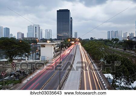 Stock Image - "Jakarta skyline, from Waduk Setia Budi Barat, Ciliwung River, right, Jakarta, Java, Indonesia, Asia". Fotosearch