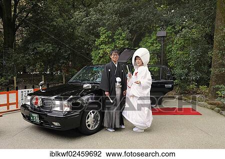"Japanese couple in kimonos, with bridal hood and kimono with brocade, standing in front of the wedding car with a red carpet, Shimogamo Jinja, Kyoto, Japan, East Asia, Asia" View Large Photo Image Stock Image - "Japanese couple in kimonos, with bridal hood and kimono with brocade, standing in front of the wedding car with a red carpet, Shimogamo Jinja, Kyoto, Japan, East Asia, Asia". Fotosearch