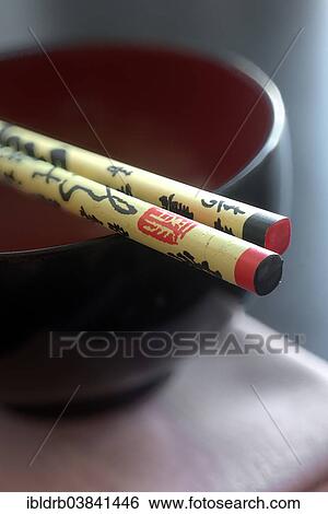 Stock Photograph - Japanese rice bowl with chop sticks and kanji. Fotosearch