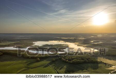 "Jathensee Lake at sunrise with mist, Roggentin, Mecklenburg Lake District, Mecklenburg-Western Pomerania, Germany, Europe" View Large Photo Image Stock Photo - "Jathensee Lake at sunrise with mist, Roggentin, Mecklenburg Lake District, Mecklenburg-Western Pomerania, Germany, Europe". Fotosearch