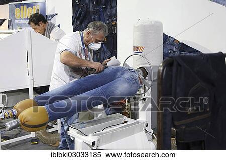 "Jean production at the stand of """"Pepe Jeans"""", the jeans getting fashionable wear and tear markings, Bread and Butter Winter 2013, fashion fair in the grounds of the former Berlin-Tempelhof airport, Berlin, Germany, Europe" View Large Photo Image Stock Photography - "Jean production at the stand of """"Pepe Jeans"""", the jeans getting fashionable wear and tear markings, Bread and Butter Winter 2013, fashion fair in the grounds of the former Berlin-Tempelhof airport, Berlin, Germany, Europe". Fotosearch