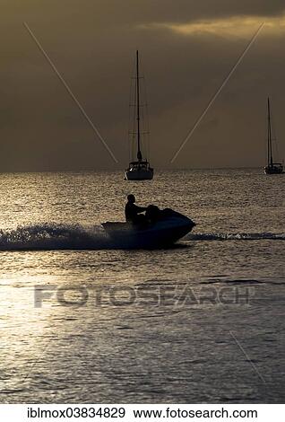 "Jet ski at dusk in Rodney Bay, Saint Lucia, Windward Islands, Lesser Antilles, North America" View Large Photo Image Stock Photo - "Jet ski at dusk in Rodney Bay, Saint Lucia, Windward Islands, Lesser Antilles, North America". Fotosearch