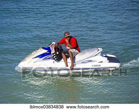 Stock Photo - "Jet Ski provider waiting for customers, Rodney Bay, Saint Lucia, Windward Islands, Lesser Antilles, North America". Fotosearch