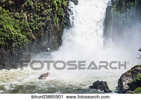 Stock Image - "Jetboat underneath the Iguazu Falls, Iguazu National Park, UNESCO World Heritage Site, Argentina, South America". Fotosearch